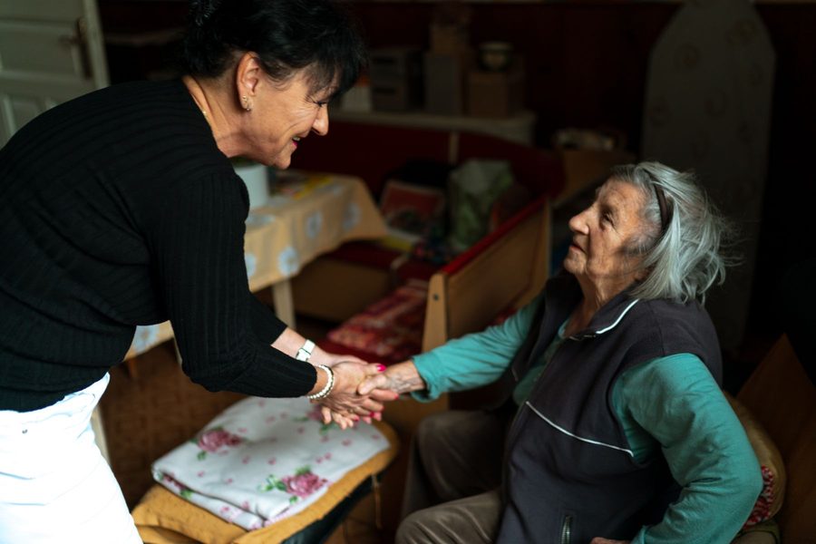 Family member and carer talking in a kitchen