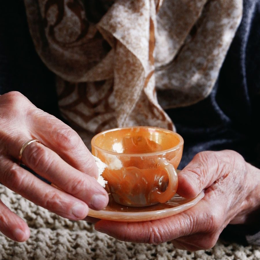 A carer sitting with a client over a cup of tea