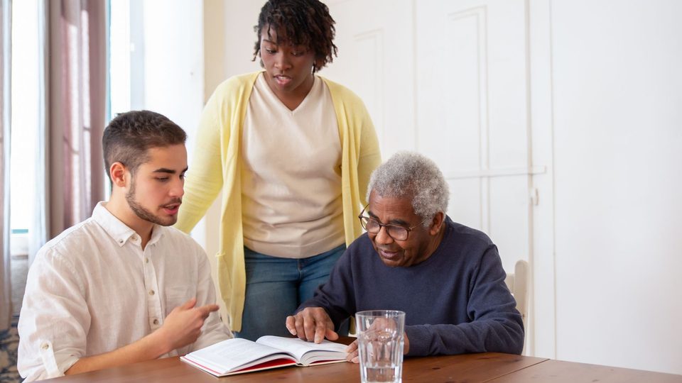 A family going through the care plan at the kitchen table